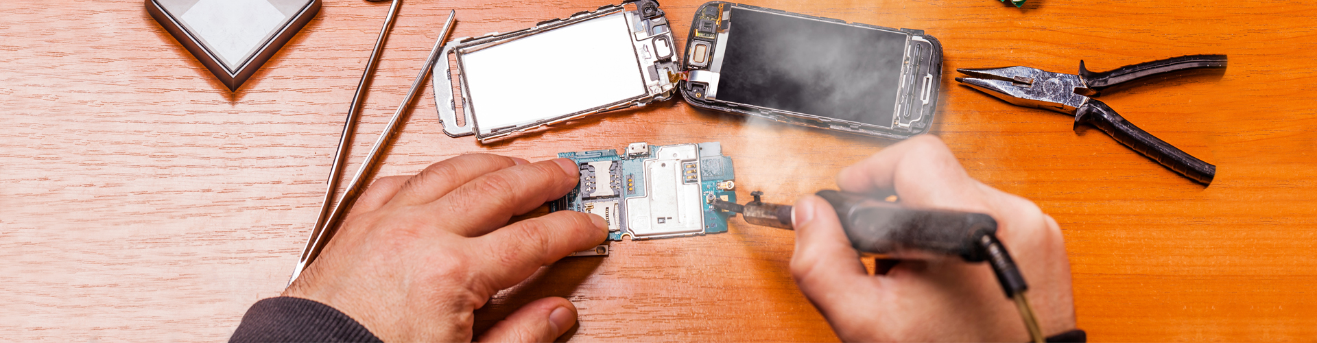 a technician soldering a phone